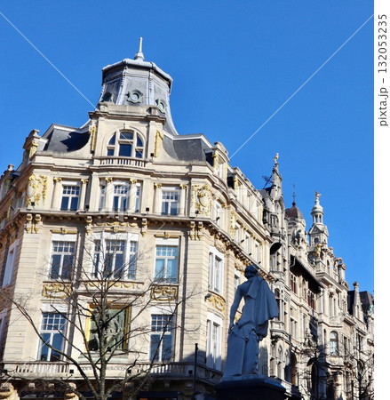 David Teniers Younger statue standing in front of ornate historic buildings on Leysstraat, Antwerp, under a clear blue sky. Belgium 132053235