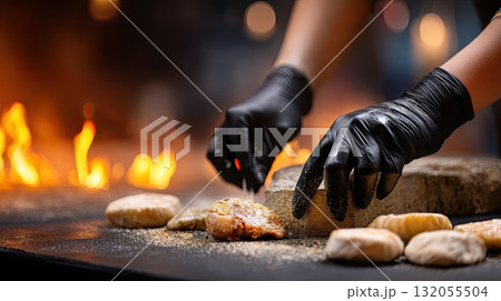 A chef expertly flips steaks on a grill, flames rising, as smoke fills the air at an outdoor cooking event surrounded by friends A chef expertly flips steaks on a grill, flames rising, as smoke fills the air at an outdoor cooking event surrounded by friends 132055504