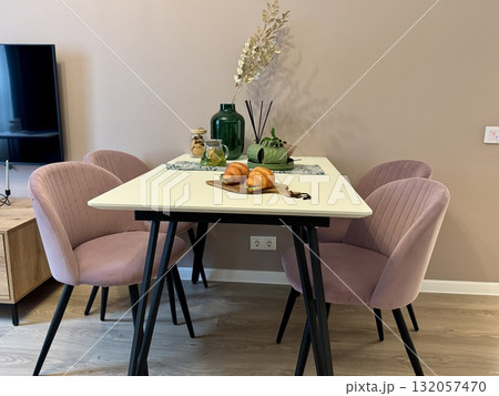 Dining area in the kitchen, table and chairs in a modern apartment Dining area in the kitchen, table and chairs in a modern apartment 132057470