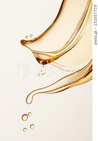 Golden liquid swirls and droplets on light background 132057719