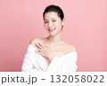 A beautiful young Asian woman with clean, fresh skin against a pink background. Skincare, facial treatment, cosmetology, beauty, and spa. An elegant portrait of an Asian woman. 132058022