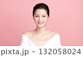 A beautiful young Asian woman with clean, fresh skin against a pink background. Skincare, facial treatment, cosmetology, beauty, and spa. An elegant portrait of an Asian woman. 132058024