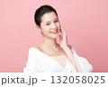 A beautiful young Asian woman with clean, fresh skin against a pink background. Skincare, facial treatment, cosmetology, beauty, and spa. An elegant portrait of an Asian woman. 132058025