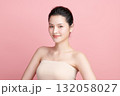 A beautiful young Asian woman with clean, fresh skin against a pink background. Skincare, facial treatment, cosmetology, beauty, and spa. An elegant portrait of an Asian woman. 132058027