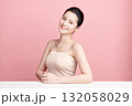 A beautiful young Asian woman with clean, fresh skin against a pink background. Skincare, facial treatment, cosmetology, beauty, and spa. An elegant portrait of an Asian woman. 132058029