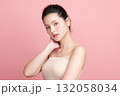 A beautiful young Asian woman with clean, fresh skin against a pink background. Skincare, facial treatment, cosmetology, beauty, and spa. An elegant portrait of an Asian woman. 132058034