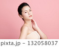 A beautiful young Asian woman with clean, fresh skin against a pink background. Skincare, facial treatment, cosmetology, beauty, and spa. An elegant portrait of an Asian woman. 132058037