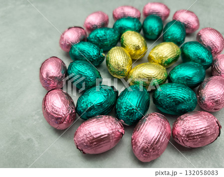 Chocolate easter eggs forming a spiral on a grey surface copy space Chocolate easter eggs forming a spiral on a grey surface copy space 132058083