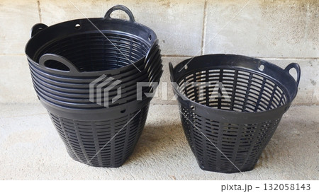 Stack of Black Plastic Strainer Baskets, Plant pot Stack of Black Plastic Strainer Baskets, Plant pot 132058143