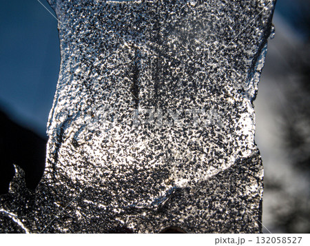 Close up of frozen icicles on a sunny day in winter. Close up of frozen icicles on a sunny day in winter. 132058527
