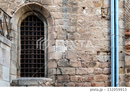 Arched window with bars. 132059913