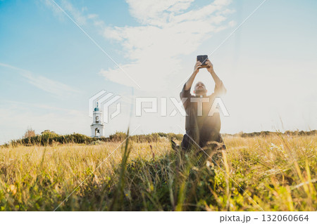 God Light Hitting A Priest Praying On The Grass 132060664