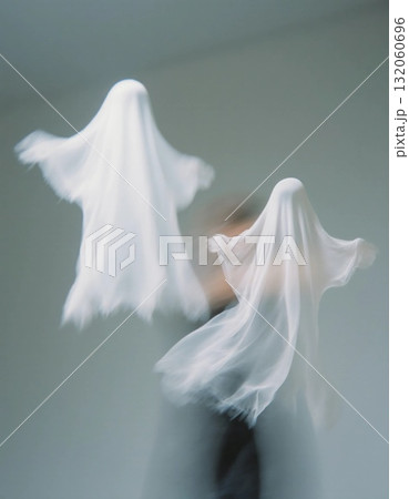 Two ethereal figures, resembling ghosts, float through the air in playful motion amidst a simple backdrop. This enchanting scene captures the spirit of joy Generative AI Two ethereal figures, resembling ghosts, float through the air in playful motion amidst a simple backdrop. This enchanting scene captures the spirit of joy Generative AI 132060696