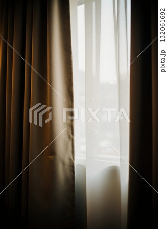 Sunlight streams softly through sheer curtains, highlighting the rich brown fabric. The peaceful scene suggests a quiet morning and offers a sense of comfort and relaxation Generative AI Sunlight streams softly through sheer curtains, highlighting the rich brown fabric. The peaceful scene suggests a quiet morning and offers a sense of comfort and relaxation Generative AI 132061692