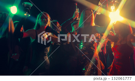 New Year Eve glamour party with people cheering in neon lights New Year Eve glamour party with people cheering in neon lights 132061777