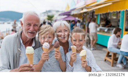 Grandparents and grandchildren joyfully enjoying ice cream together, showcasing a multigenerational bond in a vibrant outdoor setting with colorful stalls 132062174