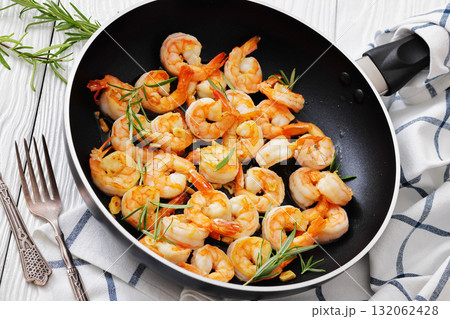 rosemary and garlic seared shrimps in a skillet rosemary and garlic seared shrimps in a skillet 132062428