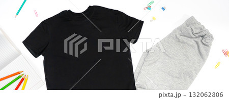 Trendy fashion T-shirt black styled basic clothes and accessories collection on white background. Flat lay, top view. Chess, book, pensils. Trendy fashion T-shirt black styled basic clothes and accessories collection on white background. Flat lay, top view. Chess, book, pensils. 132062806