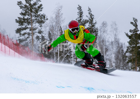 Snowboarder in bright clothes on competition snowboard cross Snowboarder in bright clothes on competition snowboard cross 132063557