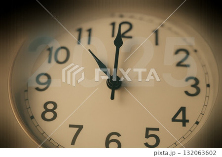 Close-up of clock with blurred 2025 symbolizing time countdown and the end of year. 132063602