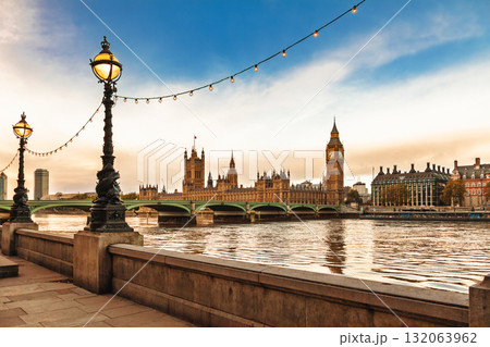 Palace of Westminster and Big Ben viewed from the South Bank with historic lamps and string lights over River Thames Palace of Westminster and Big Ben viewed from the South Bank with historic lamps and string lights over River Thames 132063962