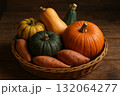 Pumpkins squashes and sweet potatoes in wicker basket on wooden table autumn harvest vegetable composition. 132064277