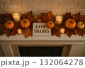 Pumpkins candles autumn leaves and sign with give thanks text on mantel thanksgiving holiday decoration concept. 132064278