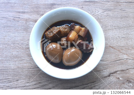 boiled egg with fat pork and fried dice tofu in herb brown soup on bowl boiled egg with fat pork and fried dice tofu in herb brown soup on bowl 132066544