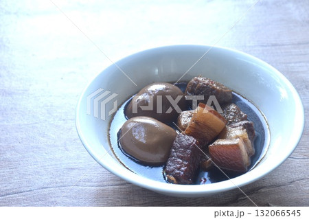 boiled egg with fat pork and fried dice tofu in herb brown soup on bowl boiled egg with fat pork and fried dice tofu in herb brown soup on bowl 132066545