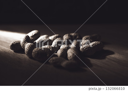 Dramatic Low Key Monochrome Peanuts in Shell on Wooden Surface 132066810