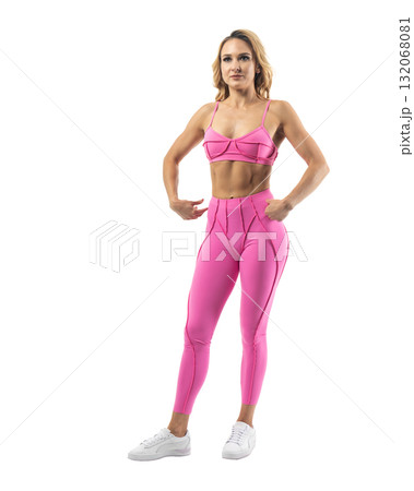 Athletic woman smiling, posing in pink fitness outfiton on transparent background 132068081
