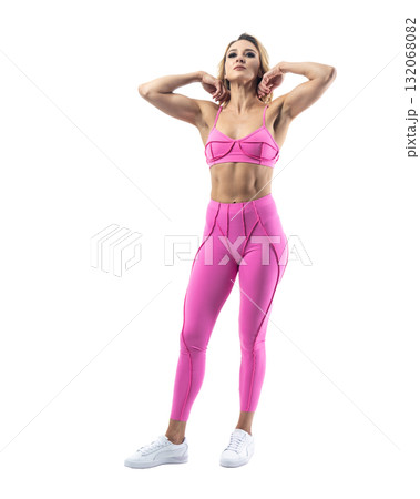 Athletic woman smiling, posing in pink fitness outfiton on transparent background Athletic woman smiling, posing in pink fitness outfiton on transparent background 132068082