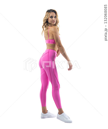 Athletic woman smiling, posing in pink fitness outfiton on transparent background 132068085