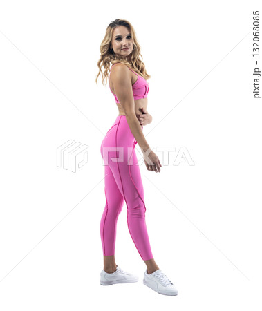 Athletic woman smiling, posing in pink fitness outfiton on transparent background 132068086