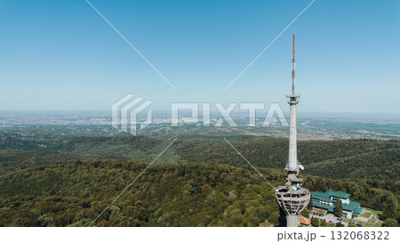 Aerial view of TV tower Iriski Venac rising above the forested hills of Fruska Gora National Park with panoramic landscapes. Was damaged by a NATO missile during the Yugoslav War Aerial view of TV tower Iriski Venac rising above the forested hills of Fruska Gora National Park with panoramic landscapes. Was damaged by a NATO missile during the Yugoslav War 132068322