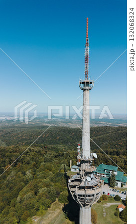 Aerial view of TV tower Iriski Venac rising above the forested hills of Fruska Gora National Park with panoramic landscapes. Was damaged by a NATO missile during the Yugoslav War Aerial view of TV tower Iriski Venac rising above the forested hills of Fruska Gora National Park with panoramic landscapes. Was damaged by a NATO missile during the Yugoslav War 132068324