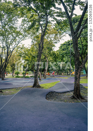 cushioned path for kids cycling or skating in park, soft track for children riding scooters or bikes and bicycle in safe playground area cushioned path for kids cycling or skating in park, soft track for children riding scooters or bikes and bicycle in safe playground area 132069186