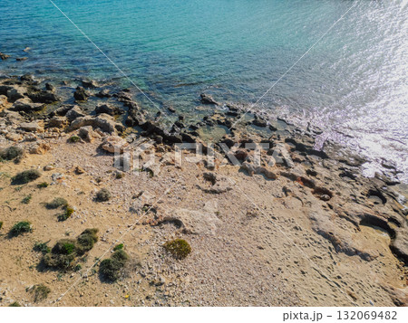 Rocky coastline on Crete island with crystal clear azure sea water under the summer sun. 132069482
