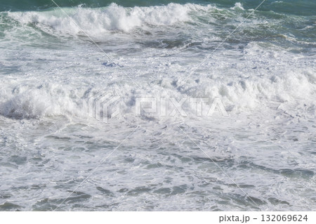 Natural marine background of stormy sea surface, powerful waves and white foam. 132069624