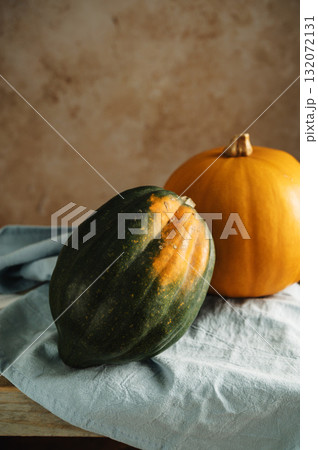 Orange and green pumpkins, rustic wooden moody background, autumn concept Orange and green pumpkins, rustic wooden moody background, autumn concept 132072131