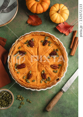 Pumpkin pie, Thanksgiving homemade crust tart, topped with pecan nuts and seeds Pumpkin pie, Thanksgiving homemade crust tart, topped with pecan nuts and seeds 132072133