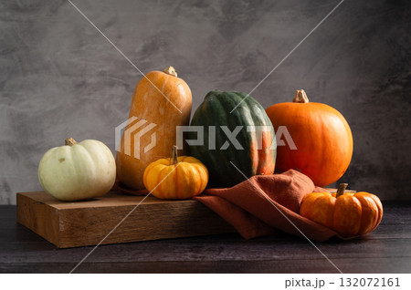 Orange pumpkins, dark moody background, autumn concept Orange pumpkins, dark moody background, autumn concept 132072161