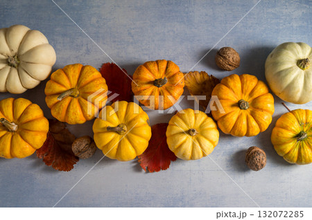 Autumn pumpkins squashes and leaves. Thanksgiving day or Halloween. Autumn background Autumn pumpkins squashes and leaves. Thanksgiving day or Halloween. Autumn background 132072285