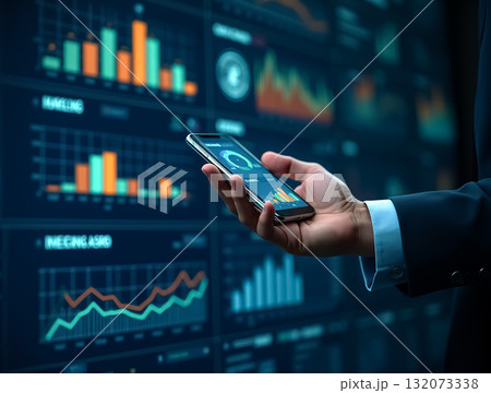 Business professional reviewing financial data on smartphone in modern office setting Business professional reviewing financial data on smartphone in modern office setting 132073338