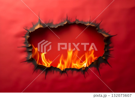 Flames visible through a torn red background, creating an intense visual effect of fire and destruction 132073607