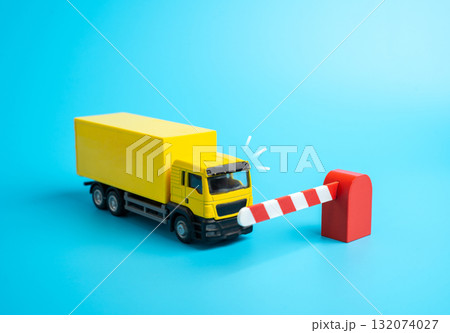A truck is blocked from entering by a barrier. Border closure and trade restriction. Import and transit bans, economic blockade, and logistics disruption. Economics, trade, and geopolitics A truck is blocked from entering by a barrier. Border closure and trade restriction. Import and transit bans, economic blockade, and logistics disruption. Economics, trade, and geopolitics 132074027