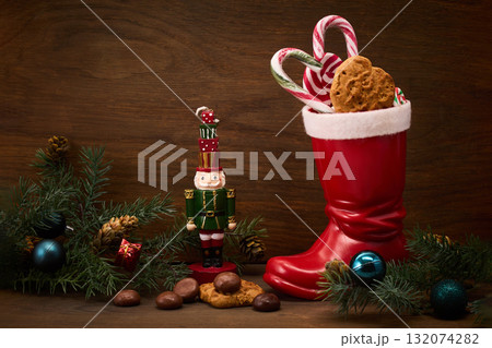 St. Nicholas Day. Red boot with sweets, spicy ginger cookies and gifts for December 6th St. Nicholas Day. Red boot with sweets, spicy ginger cookies and gifts for December 6th 132074282