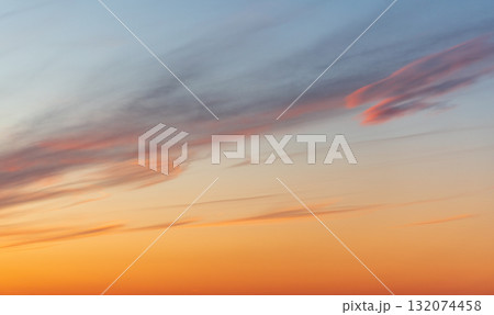 A tranquil sunset fills the sky with warm orange hues near the horizon A tranquil sunset fills the sky with warm orange hues near the horizon 132074458