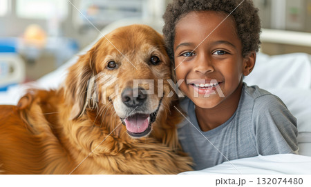 Happy child with golden retriever dog in hospital bed sharing joy 132074480