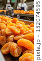 Close-up of dried apricots on industrial conveyor in factory 132074595